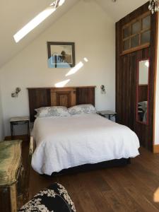 a bedroom with a large bed with white sheets at Horizon Barn in Market Rasen