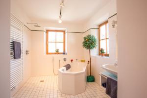 a bathroom with a tub and a sink at Hormannhof in Linden