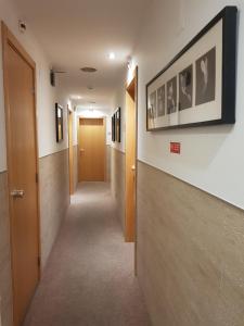 a hallway with a hallway leading to a room with a door at Paradouro in Lisbon