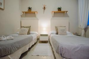 Łóżko lub łóżka w pokoju w obiekcie Hostal Vidamia