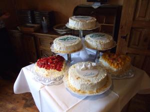 a table topped with cakes on top at Hotel Forsthaus in Volkesfeld