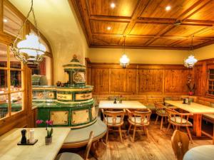 a restaurant with wooden walls and tables and a stove at Hotel-Gasthof Neumühle in Thiergarten
