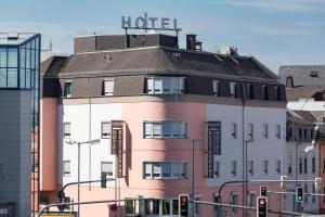 a hotel building with a sign on top of it at Hotel Martin in Limburg an der Lahn