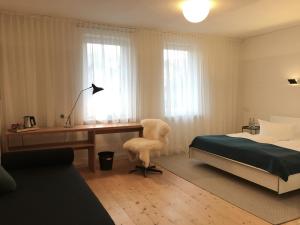 a bedroom with a desk and a bed and a desk and chair at Harzer Hof in Herzberg am Harz