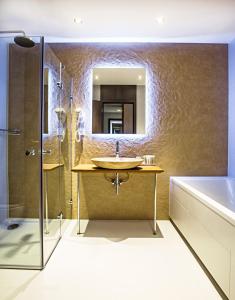 a bathroom with a sink and a shower and a tub at Sand Martin in Mladá Boleslav