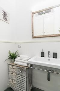 a bathroom with a sink and a mirror at Tevere Rome Apartments in Rome