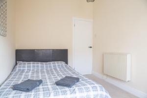 a bedroom with a bed with two pillows on it at Ibstock Self Catered Apartment in Ibstock