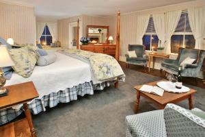 a bedroom with a large bed and two chairs at Inn at Jackson in Jackson