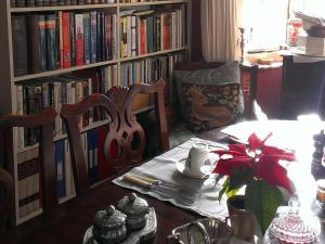 a dining room with a table and a book shelf with books at Iolanthe in London