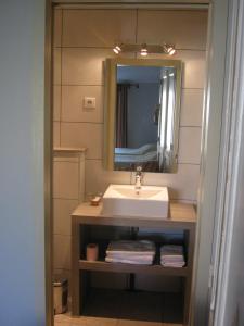 y baño con lavabo y espejo. en Les Jardins De La Livrée, en Villeneuve-lès-Avignon