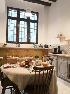 a table in a kitchen with a table cloth on it at L'Oisellerie Meublé de Tourisme in Angers