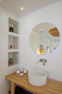a bathroom with a white sink and a mirror at Avanti in Ios Chora