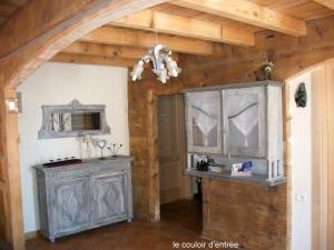 a kitchen with a wooden ceiling and a cabinet at Ker Cambre in Saint-Pierre-dels-Forcats