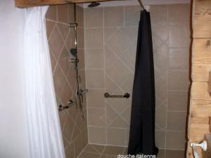 a shower with a black shower curtain in a bathroom at Ker Cambre in Saint-Pierre-dels-Forcats