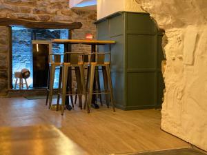 
a kitchen with a wooden table and chairs at The Golden Fleece Inn in Porthmadog
