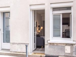 a building with two windows and a doorway at La Cle des Expos "In Paris" in Vanves