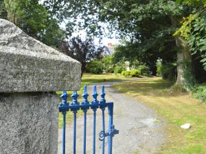 a blue metal fence next to a road at Kiltariff Hall Country House in Rathfriland
