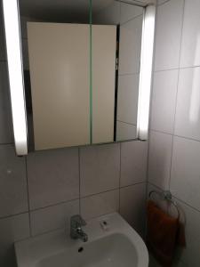 a bathroom with a sink and a mirror at Hotel Haus Hildegard - Garni 3 Sterne superior in Niederkrüchten