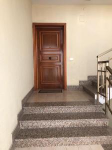 a wooden door on the side of a building with stairs at Appartamento Gemma in Martinsicuro