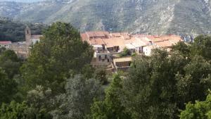 a group of buildings in a village in the mountains at Casa Leonor in Bel