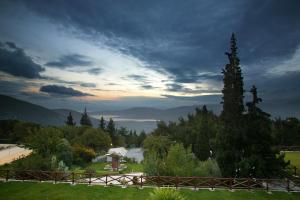 a view of a field with a fence and trees at Amalia Hotel Delphi in Delfoi
