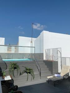 a balcony with stairs and a swimming pool at Soho Boutique Sevilla in Seville