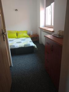 een slaapkamer met een bed met gele kussens en een raam bij Villa Hillas in Reda