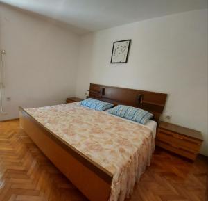 a bedroom with a large bed and a clock on the wall at Apartment Boris in Labin