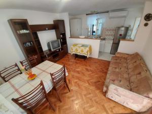 a living room with a table and chairs and a kitchen at Apartment Boris in Labin