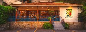 a building with a restaurant with stairs in front of it at Orosi Lodge in Orosí