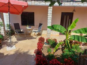a patio with an umbrella and a table and chairs at Apartment Boris in Labin +5 photos