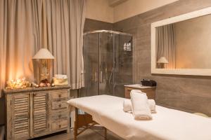 a bathroom with a shower and a bed with towels at Hotel Stella Della Versilia in Marina di Massa