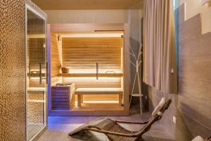 a bathroom with a sauna with a tub in it at Hotel Stella Della Versilia in Marina di Massa