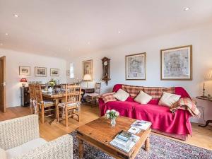 a living room with a red couch and a table at Knole B&B in Sevenoaks