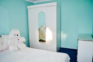 Iltsi的住宿－ЮрДар，坐在床上的白泰迪熊