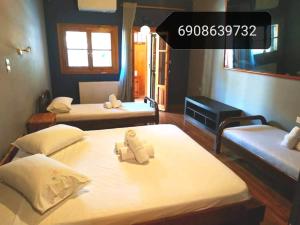 a bedroom with two beds with towels on them at Lefkada Villas Panoramic in Katouna