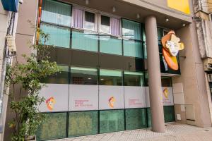 a building with a cow sign on the side of it at Roberta Rosa De Fontana Suites in Rosario