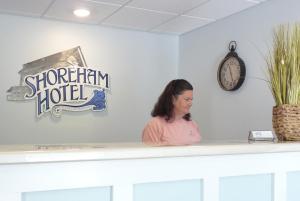 a woman standing at a counter in a store at Shoreham Oceanfront Hotel in Ocean City