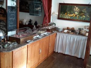 a kitchen with a counter with food on it at Landgasthof Kleine Kommode in Zorge