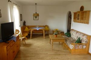 a living room with a couch and a table at Landgasthof Berg in Eurasburg