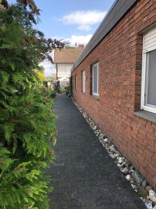 a brick alleyway next to a brick building at Landgasthof Rheda Hotel - Restaurant in Rheda-Wiedenbrück