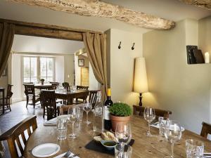 a dining room with a table with wine glasses at The Masons Arms in Cirencester