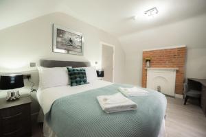 a bedroom with a large bed and a fireplace at Laurel House in Reading