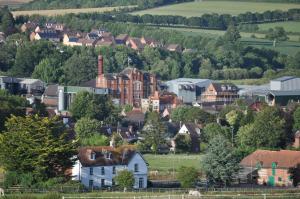 a town with houses and trees in the distance at Lower Bryanston Farm in Blandford Forum