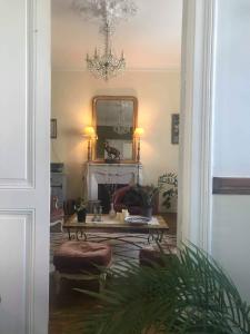 a living room with a table and a mirror at Le 14 St Michel in Josselin
