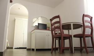 a dining room with a table and two chairs at Hotel O'scià in Lampedusa