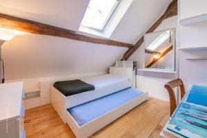 a room with a bed and a window at Le Colombier - Fairytale Factory in Montgeroult