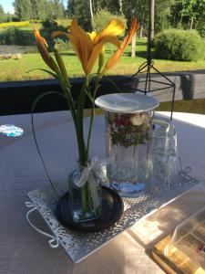 une fleur jaune dans un vase sur une table dans l'établissement Stay at hosts, à Rēzekne