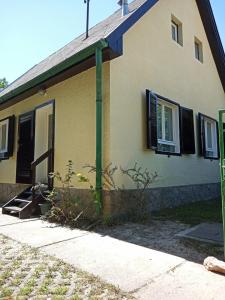 a house with a green pole in front of it at Borostyán Vendégház Dunasziget in Dunasziget