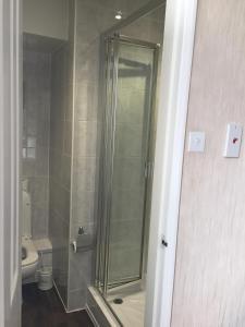 a shower stall in a bathroom with a toilet at The Leeway in Scarborough